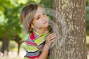 Little boy spying in the park