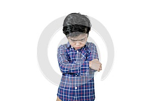 Little boy standing with cranky expression