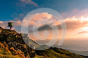 A little boy standing on a large rocky rock admires the landscape of the Carpathians, the top of Mount Pip Ivan Chornohirsky