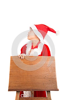 Little boy standing over wooden station board on white