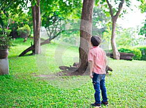 Little boy standing in the park outdoor