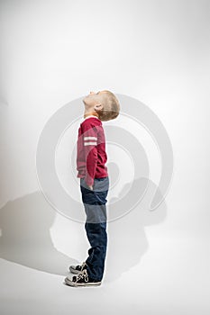 Little Boy Standing Sideways and Looking Up