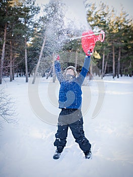 A little boy that is standing in the snow