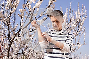 Little boy suffering from seasonal allergy outdoors