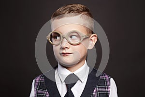 Little boy in suit and glasses