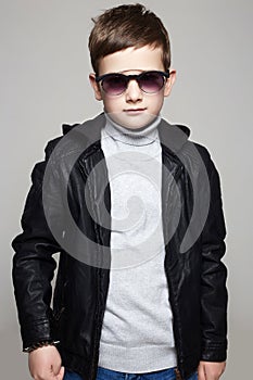 Little boy in sunglasses. stylish kid in leather