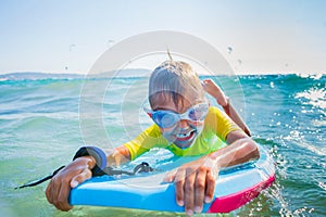 Little boy surfboarding