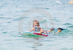 Little boy surfboarding