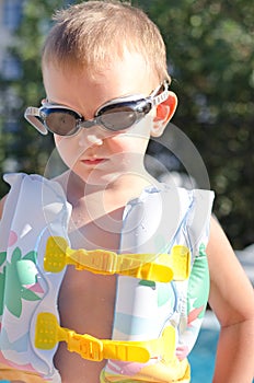 Little boy in swimming goggles on a hot summer day