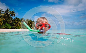 Little boy swimming with mask at sea