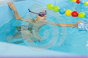 Little boy swimming in pool, kid in glass learning swim by crawls . Sport and hardening. Healthy mind. children`s