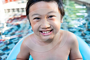 Little boy in the swimming pool. Summer holiday concept