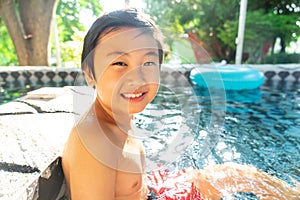 Little boy in the swimming pool. Summer holiday concept