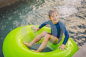 Little boy swimming with rubber ring at the leisure center