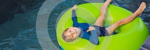 Little boy swimming with rubber ring at the leisure center BANNER, LONG FORMAT