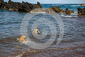 Little boy swimming in the sea. Kid on a tropical beach. Summer kids vacation.