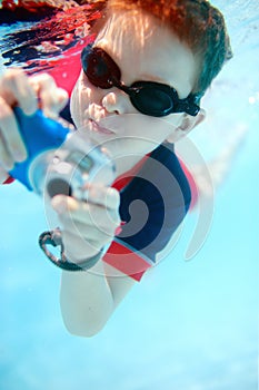 Little boy swimming underwater