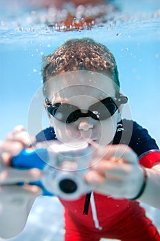 Little boy swimming underwater