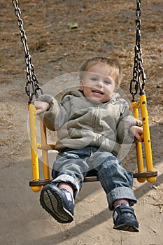 Little boy on a swing