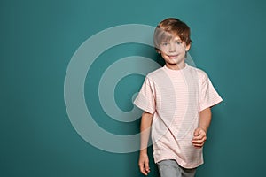 Little boy in t-shirt on color background