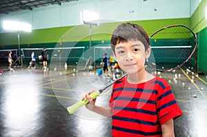 Little boy taking badminton racket in training class