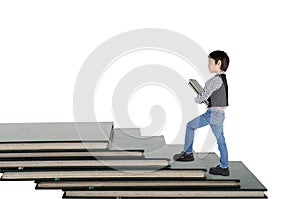 Little boy taking book go up book step