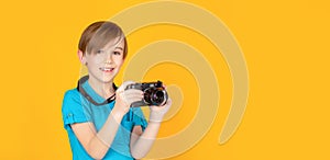 Little boy on a taking a photo using a vintage camera. Child in studio with professional camera. Boy using a cameras