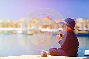 Little boy taking photos while travel in Europe, Malta