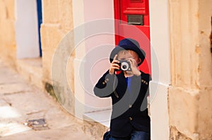 Little boy taking photos while travel in Europe, Malta