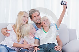 Little boy taking pictures of his family