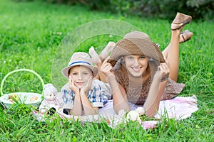 Little boy and teen age girl having picnic outdoors