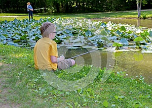 A little boy and a teenage girl fishing photo