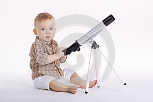 Little boy with telescope exploring stars