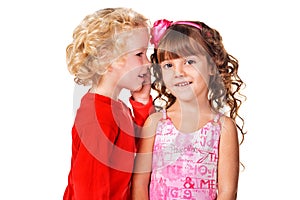 Little boy tell a secret to a little girl photo