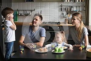 Little boy telling story, poems standing on chair at breakfast