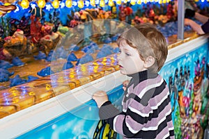 Little boy of three years at a funfair, outdoors