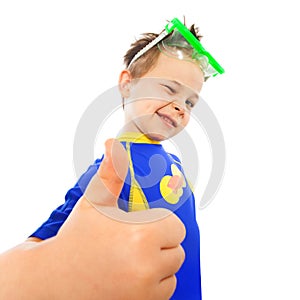 Little boy with thumbs up gesture at sea