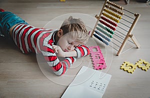 Little boy tired and stressed of doing homework