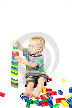 A little boy to build a tower of Lego photo