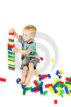 A little boy to build a tower of Lego photo