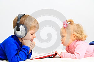 Little boy and toddler girl with headset using
