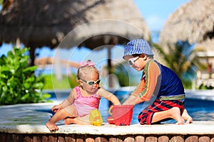 Little boy and toddler girl playing at beach