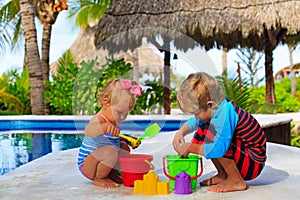 Little boy and toddler girl playing in swimming