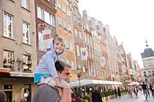 Little boy on top of his father's shoulders