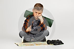 Little boy tourist with binoculars