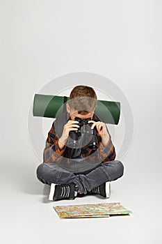 Little boy tourist with binoculars