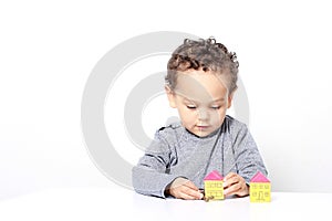 Little boy with toy building blocks stock photo