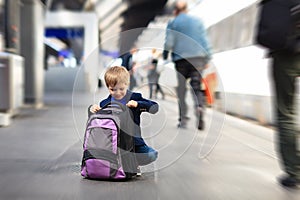 Little boy travel by train waiting on tube platform