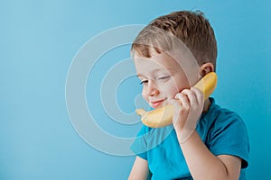 Little Boy tries to speak by means of a banana instead of phone