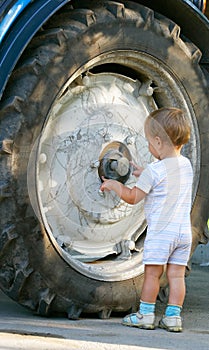 Little boy and truck wheel